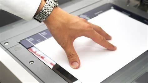a man is scanning paper